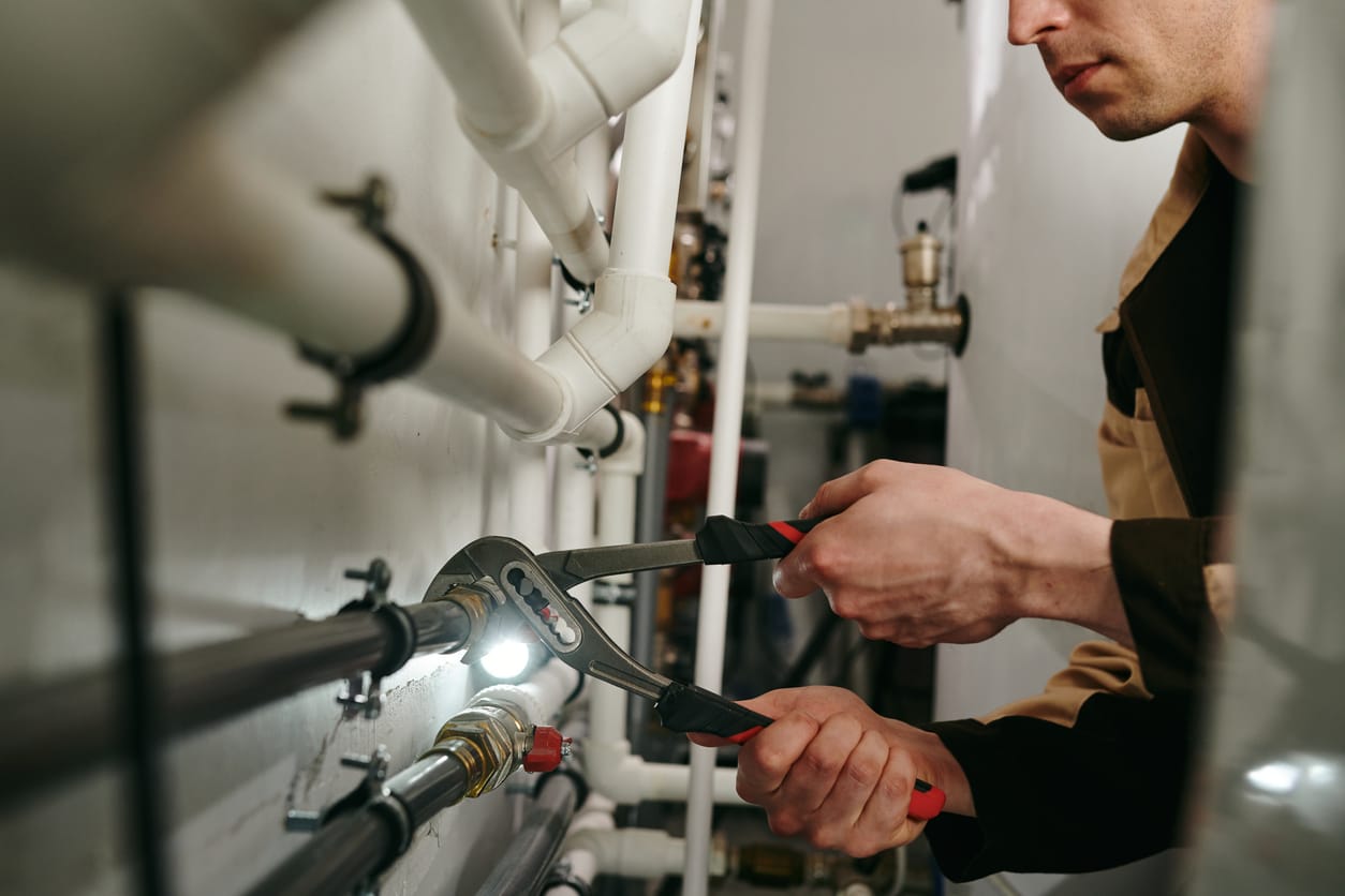 Plumbers maintaining commercial plumbing pipes in Carlsbad
